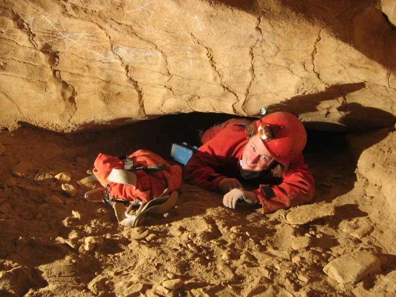 Leeanne coming through a crawl about a foot high.